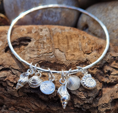 Custom silver rock pool bangle, with personalised engraved charm