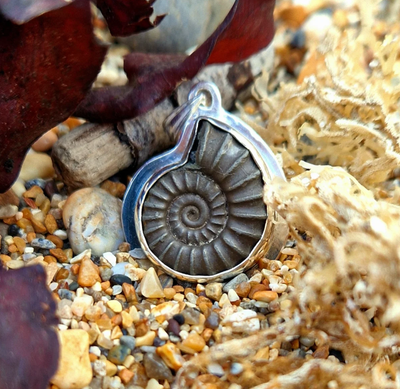 Bespoke silver pendant setting for an iron pyrite ammonite