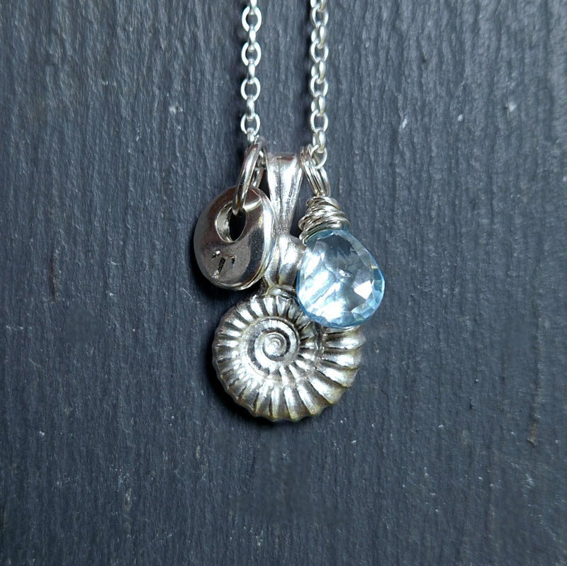 cast ammonite pendant, sky blue topaz and engraved pebble charm, 2024