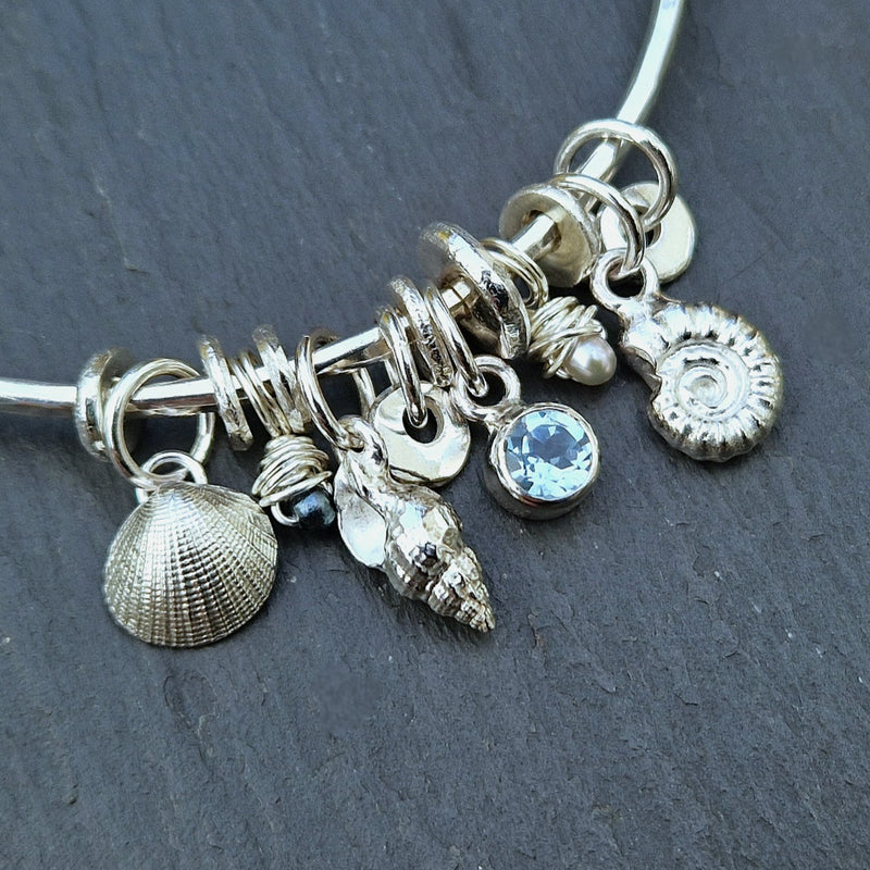 silver and sky blue topaz bespoke rock pool bangle, 2025