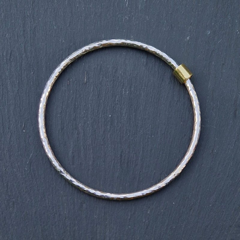 Silver beaten halo bangle with 18ct gold bead, 2023